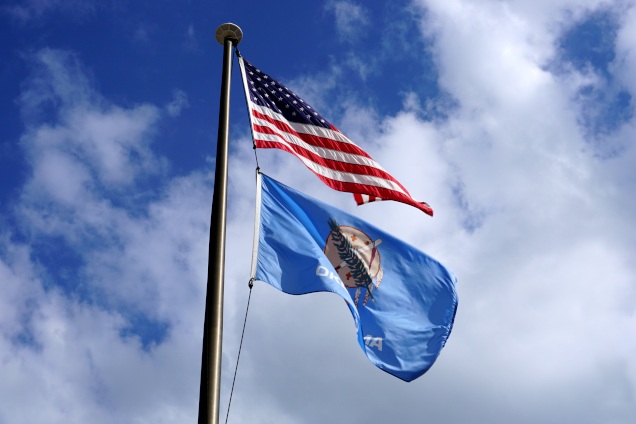 An American flag and Oklahoma state flag in the breeze